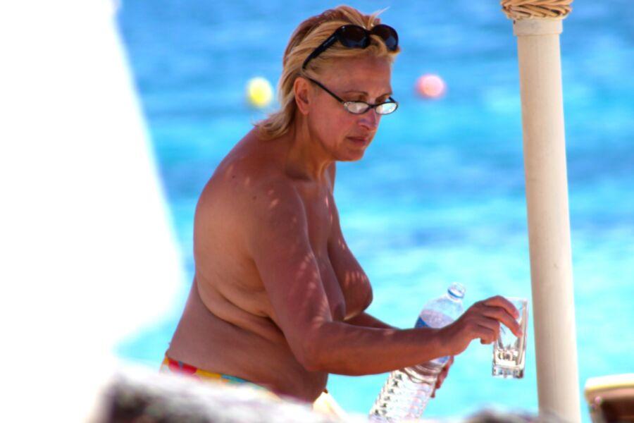 Free porn pics of Blonde mature caught topless in Ornos beach, Mykonos 3 of 8 pics